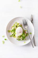 breakfast avocado sandwich with poached egg and feta cheese