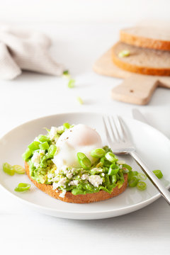 breakfast avocado sandwich with poached egg and feta cheese
