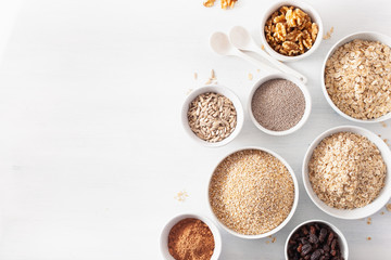 variaty of raw cereals and nuts for breakfast. Oatmeal flakes and steel cut, barley, walnut, chia, raisins. Healthy ingredients