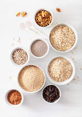 variaty of raw cereals and nuts for breakfast. Oatmeal flakes and steel cut, barley, walnut, chia, raisins. Healthy ingredients