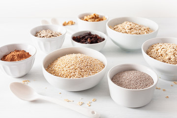 variaty of raw cereals and nuts for breakfast. Oatmeal flakes and steel cut, barley, walnut, chia, raisins. Healthy ingredients