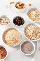 variaty of raw cereals and nuts for breakfast. Oatmeal flakes and steel cut, barley, walnut, chia, raisins. Healthy ingredients