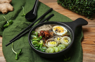 Tasty Chinese soup in bowl on table