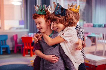 Positive delighted classmates celebrating their best friend