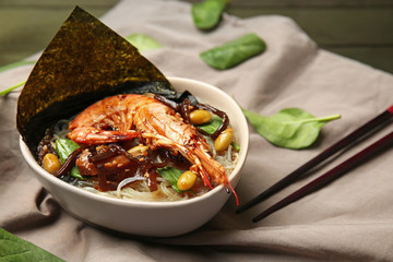 Tasty Chinese soup with shrimp in bowl on table