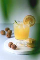 Tasty Orange Juice in Glass With Ice Cube Blue and White Background Fresh Oranges Vertical