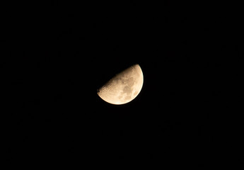 The half moon(waxing moon) in the night sky.