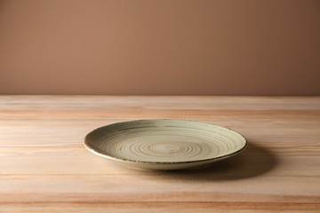 Stylish plate on wooden table