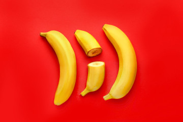 Tasty cut bananas on color background