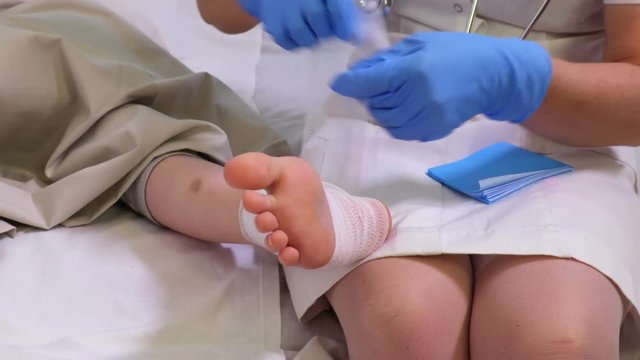 Nurse keeping child injured leg
