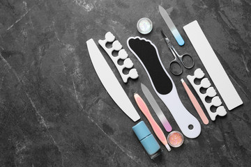 Set of professional tools for pedicure on grey background