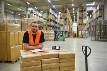 smiling workers in a warehouse of a forwarding agency - trade and delivery of goods // Portrait...