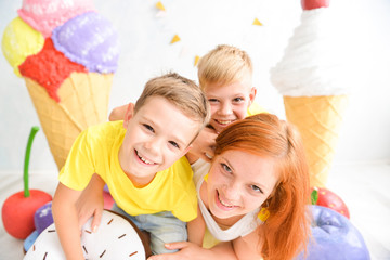 Candy Bar with Sweets. Cake, cookies, creamy muffins, fresh berries for celebratory birthday. birthday decorations in the studio, a huge candy bar for a kids party. mother with sons, brothers