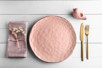 Beautiful table setting with floral decor on wooden background