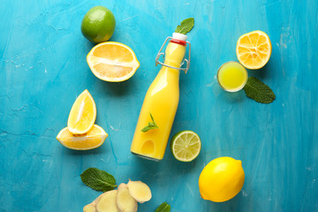 Bottle of healthy juice with ingredients on color background