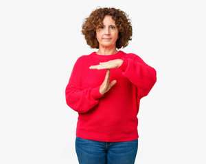 Beautiful middle ager senior woman red winter sweater over isolated background Doing time out...