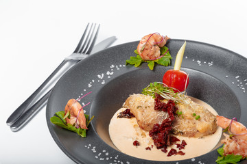 fish fillet with sauce baked and decorated