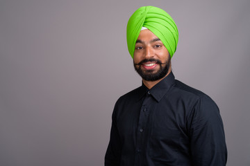 Young Indian Sikh businessman wearing green turban