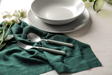 Beautiful table setting with floral decor on white wooden background
