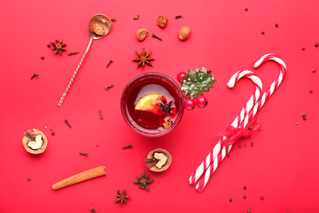 Composition with cup of tasty mulled wine on color background