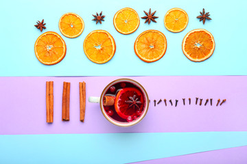 Composition with cup of tasty mulled wine on color background