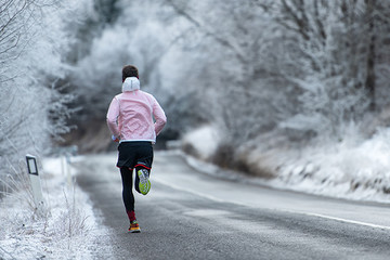 Running during training on icy road in winter
