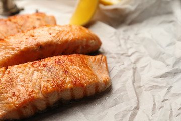 Pieces of tasty grilled salmon on table, closeup