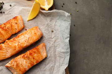 Pieces of tasty grilled salmon on table