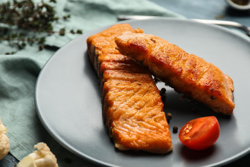 Pieces of tasty grilled salmon on plate, closeup
