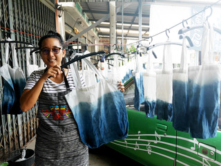 hai women working Indigenous knowledge of thailand tie batik dyeing indigo color or mauhom color...