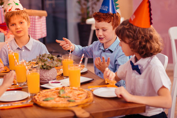 Positive delighted teenagers having friendly talk together