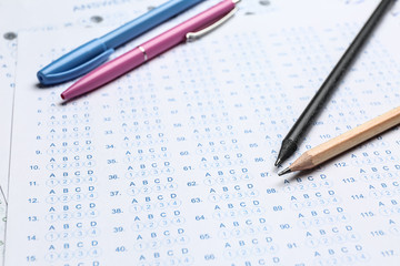 Pencils on blank answer sheet, closeup. Concept of passing exam