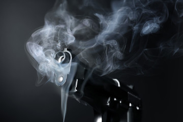 Smoking gun on dark background