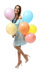 Beautiful young woman with balloons on white background