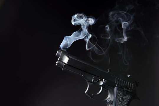 Smoking gun on dark background