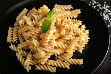 Plate with tasty pasta on table, closeup
