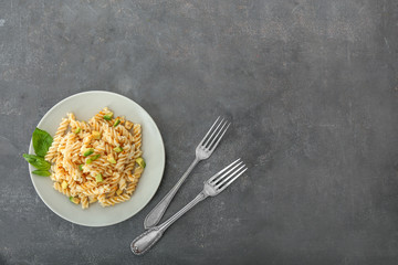 Plate with tasty pasta on grey table