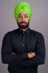 Young Indian Sikh businessman wearing green turban