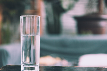 Glasses of water on a wooden table.