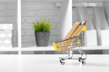 Mini shopping cart with multi-colored pens and pencils