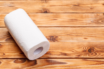 Roll of paper towel on wooden background
