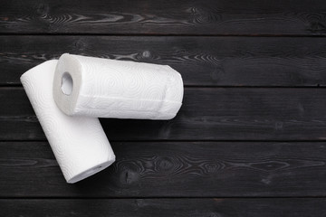 Roll of paper towel on wooden background