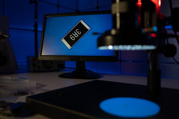 Laboratory of semiconductor chips. The development of modern electronics. crystal chip in the microscope