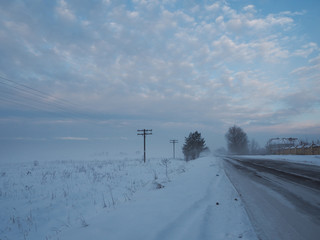Cloudy sky over winter road