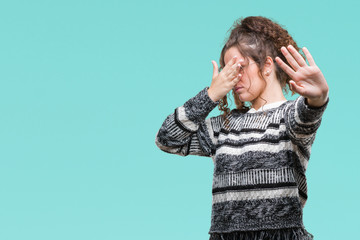 Beautiful brunette curly hair young girl wearing glasses over isolated background covering eyes with hands and doing stop gesture with sad and fear expression. Embarrassed and negative concept.