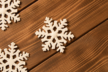 Several funny toy snowflakes on wooden background