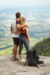 Athletic couple in sportswear admiring view