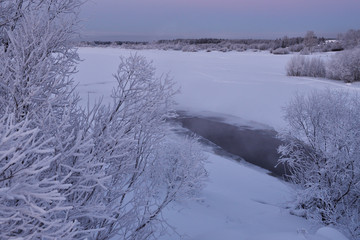 Fototapeta na wymiar Frosty sunset on the river bank.