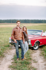 A guy and a girl travel outside the city by car.