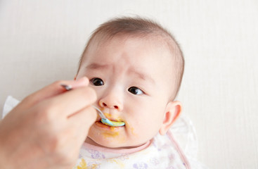 Cute Asian baby being fed